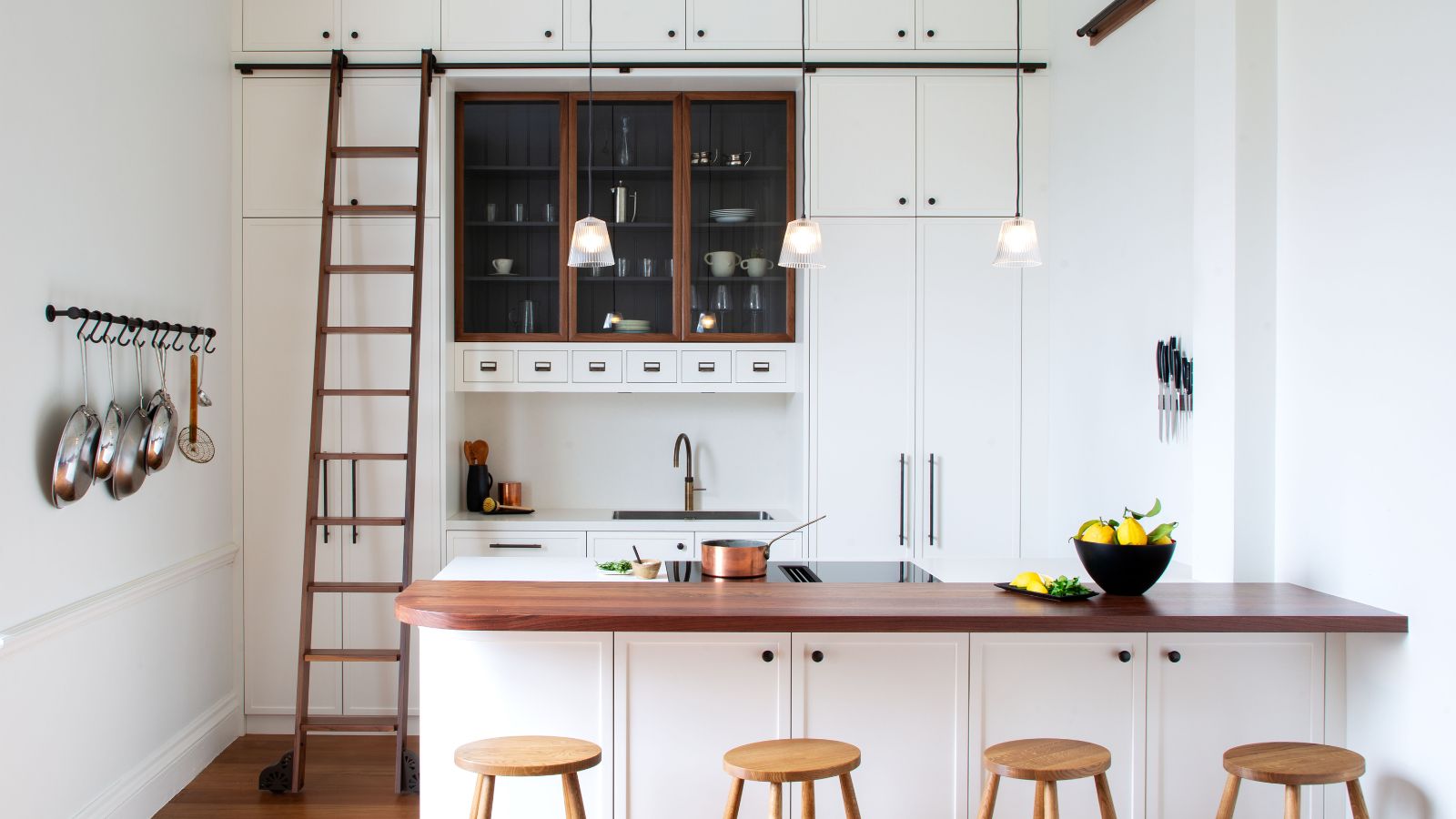 A white kitchen with a oak kitchen ladder